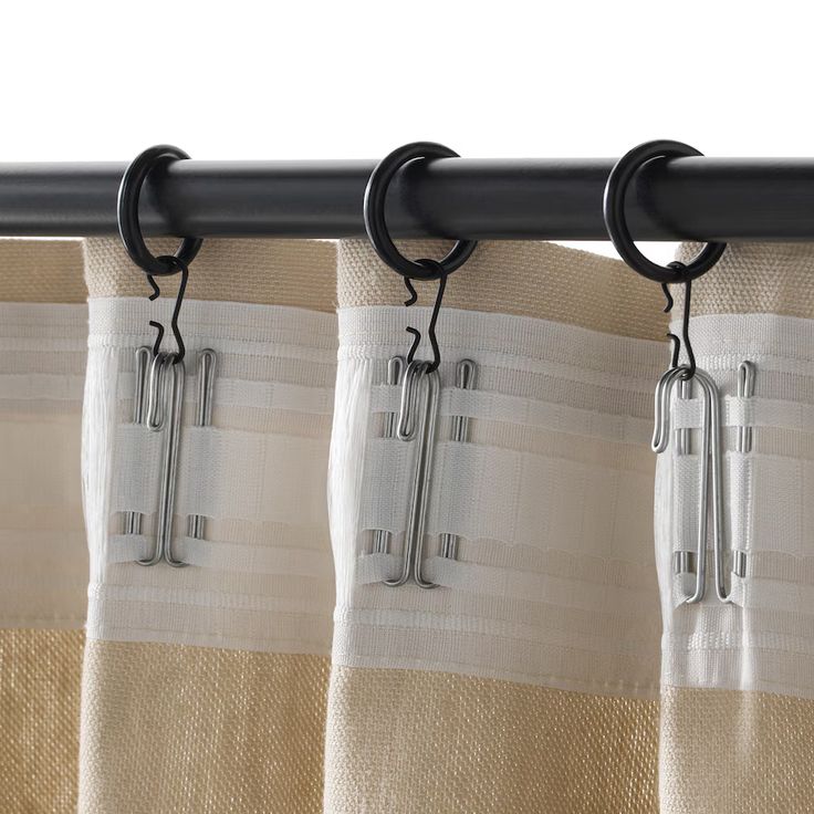 white sheer curtains hanging on a tension rod in a bright window