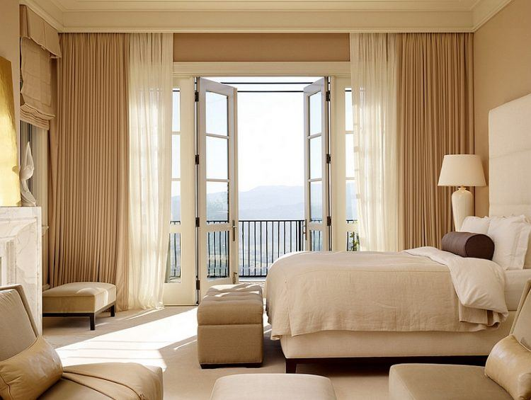 Modern bedroom with floor-to-ceiling beige blackout curtains, sheer curtains, and French doors.