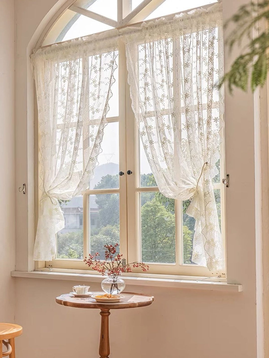 Charming small café-style curtains hung on a compact kitchen window