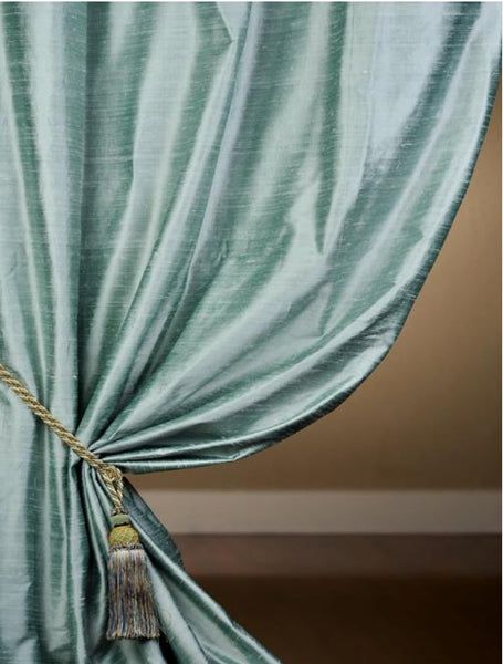 Elegant living room featuring floor-length luxurious silk drapes