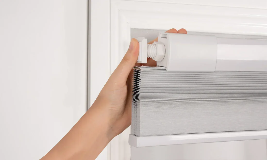 No-drill motorized curtains installed above large windows controlled with a smart remote