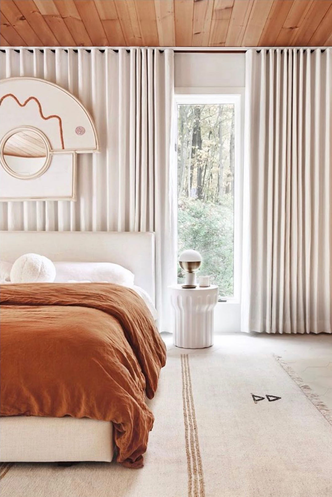Modern bedroom with pleated blackout curtains, minimalist decor, and natural wood ceiling