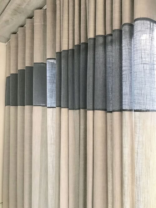 Modern living room with large color block curtains in blue, gray, and white