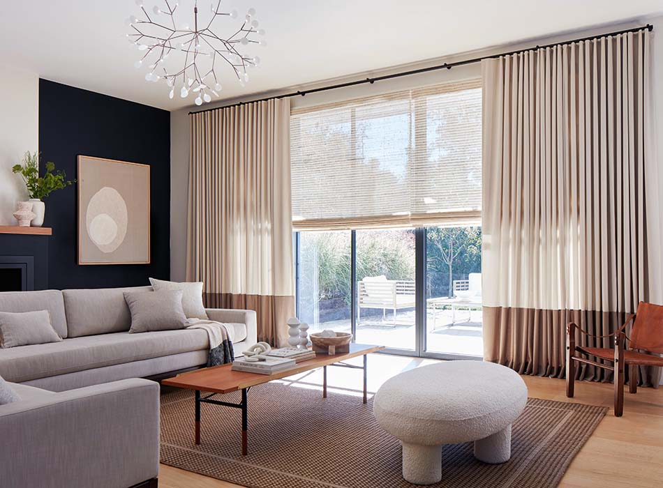 Modern living room with floor-to-ceiling blackout curtains, sheer blinds, and stylish furniture