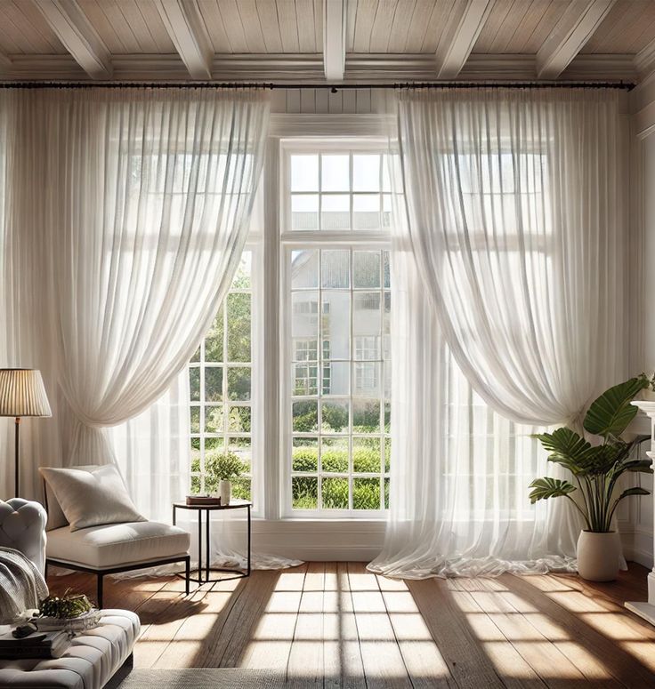 Bright living room with sheer white curtain panels on large windows, wood floor, modern decor