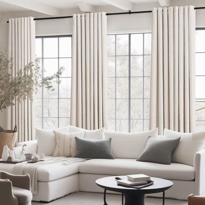 Modern living room with beige blackout curtains, large windows, and a white sectional sofa.