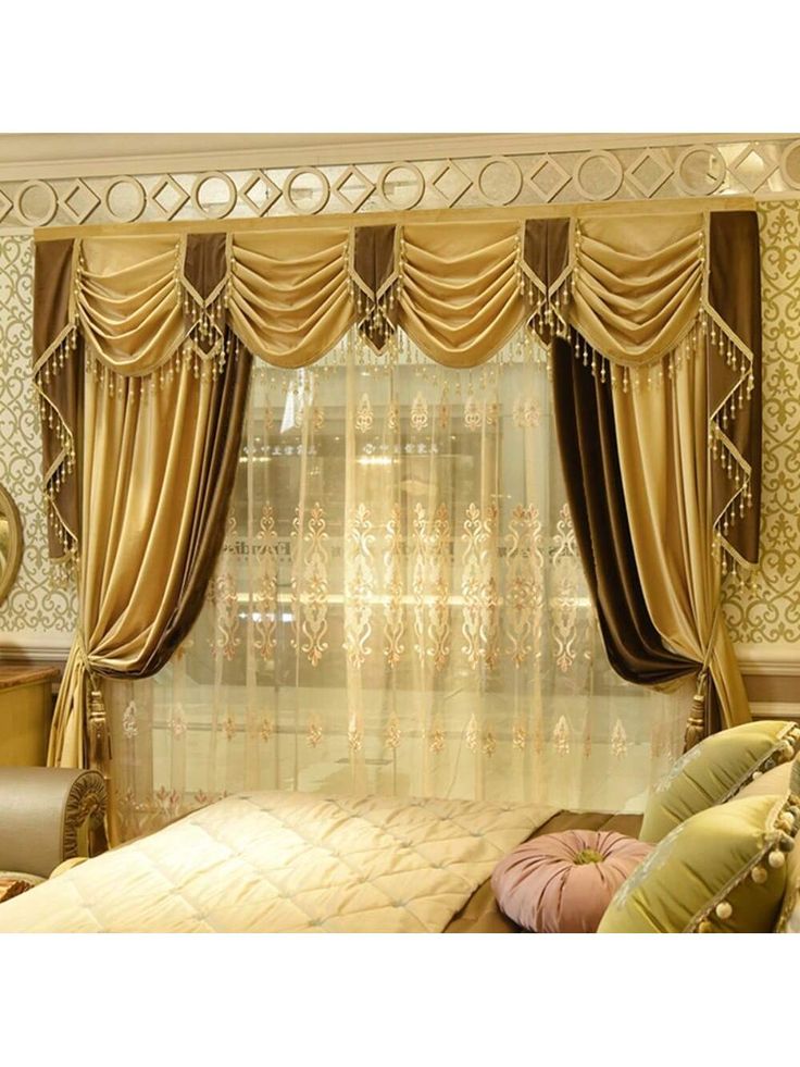 Luxury gold and brown blackout curtains with swag valance and sheer embroidered drapes in an elegant bedroom.