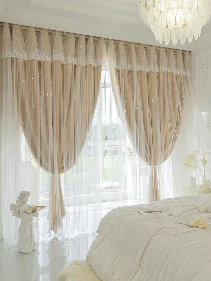 Elegant bedroom with sheer beige curtain panels, lace valance, and natural light from bay window