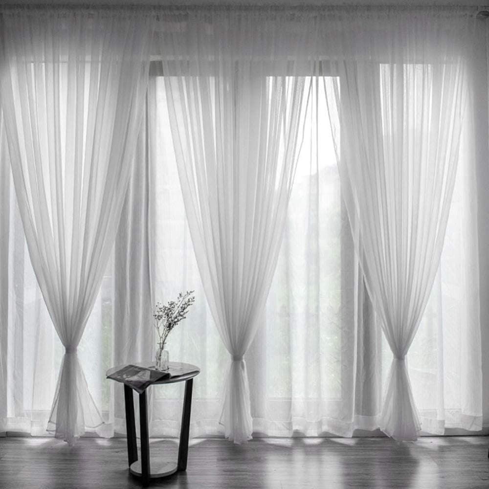 Elegant living room featuring floor-length custom blackout curtains in neutral tones