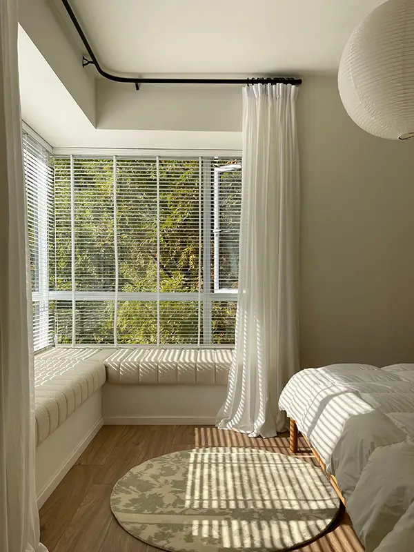 Stylish corner window curtains in a sunlit modern interior