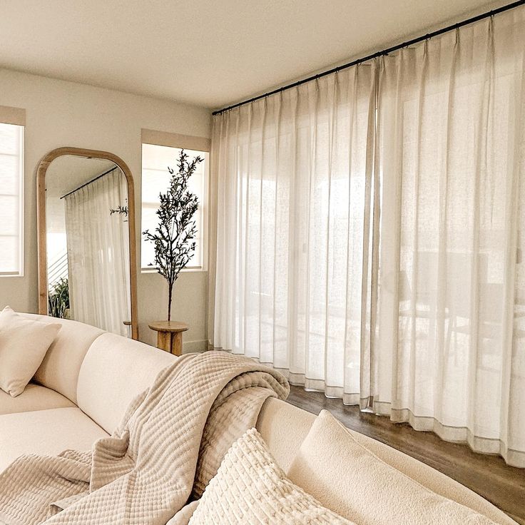 modern ripple fold drapes in a chic, minimalist living room