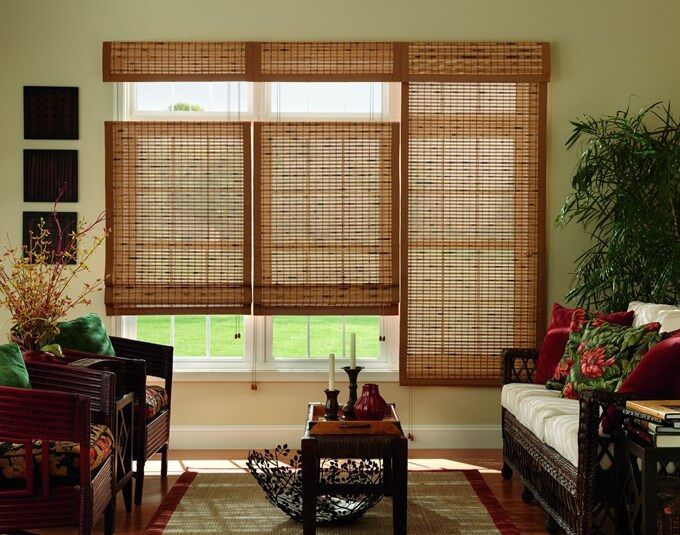 Living room with bamboo roller blinds, woven curtains, and tropical-inspired decor