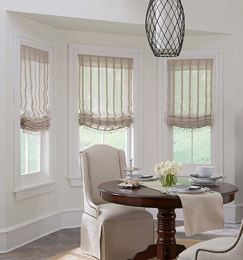 Elegant blackout Roman shades in modern bedroom with complete light blockage