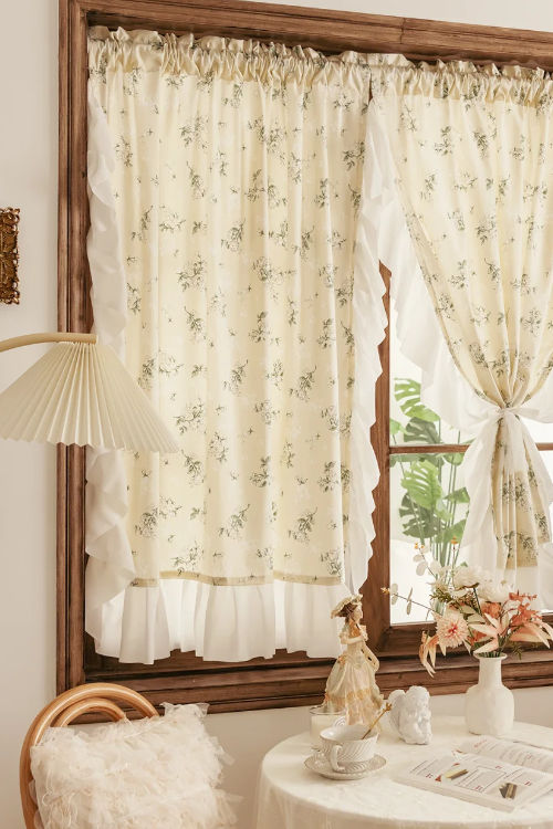 Cream floral ruffled curtains on a wooden window, vintage decor, cozy living room setting