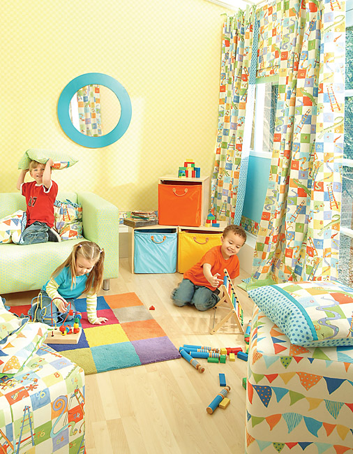 Children playing in a colorful, modern playroom with patterned blackout curtains and toys