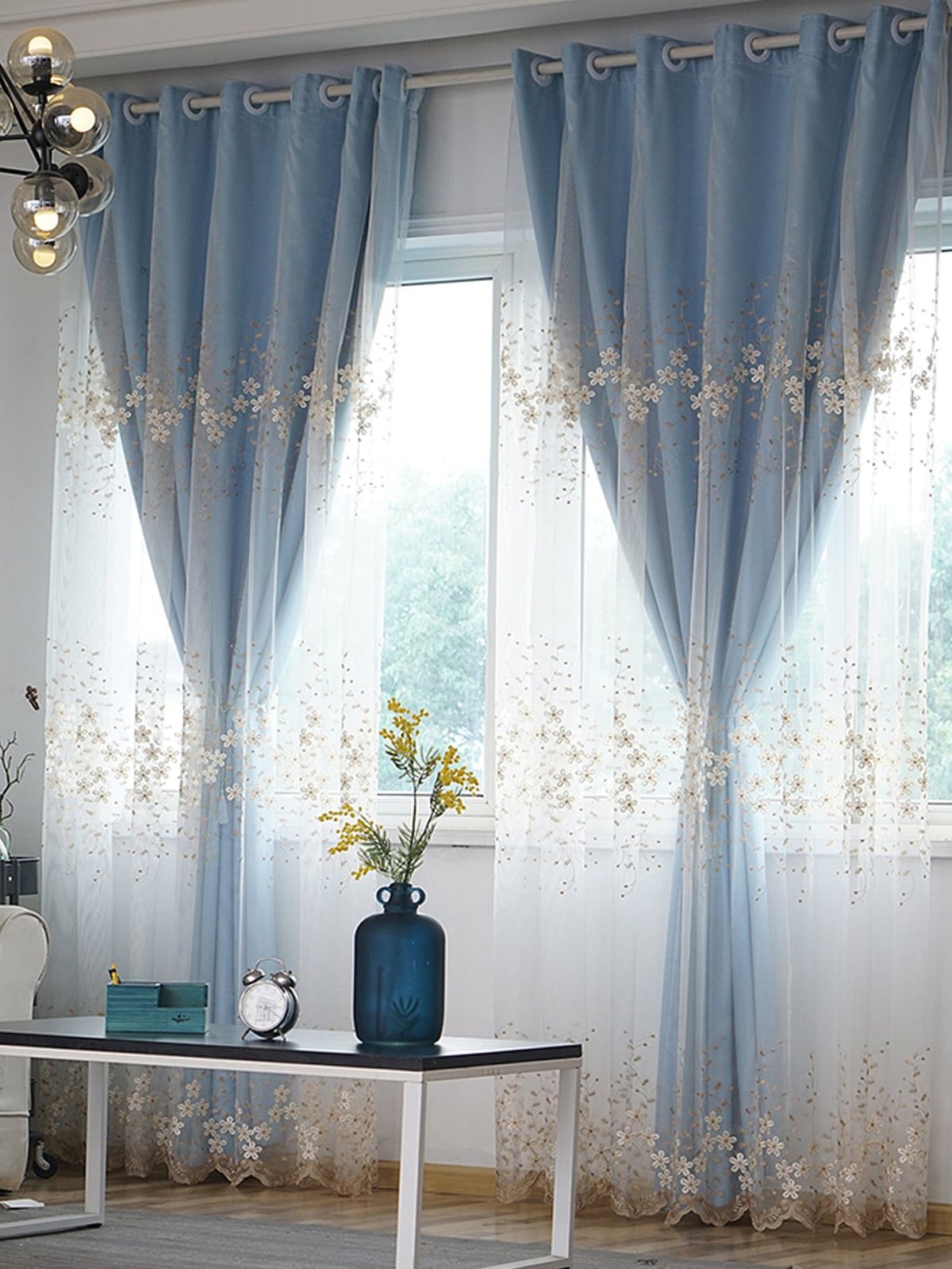 Elegant living room with navy blue drapes framing large windows and complementing neutral décor