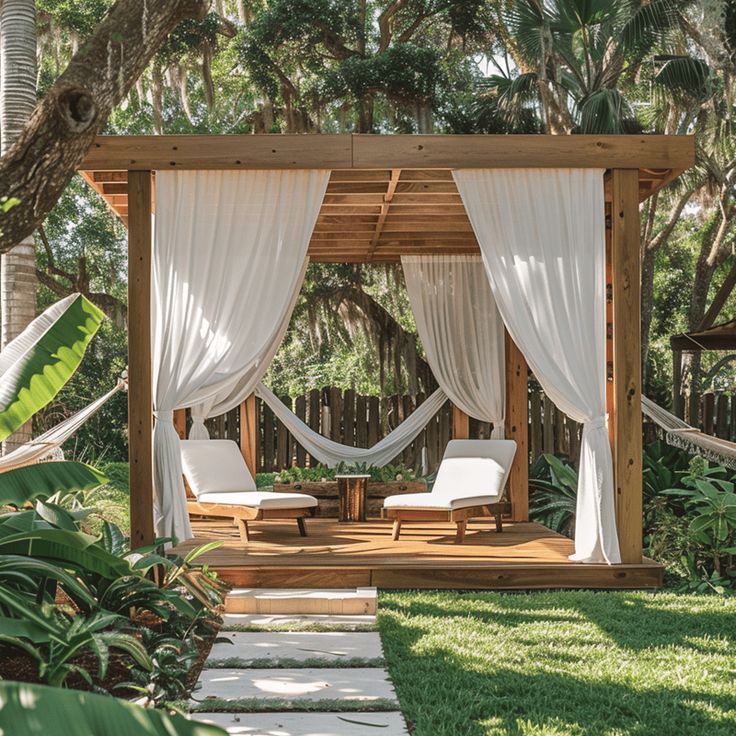 White outdoor drapes flowing gently on a wooden pergola with cozy seating underneath