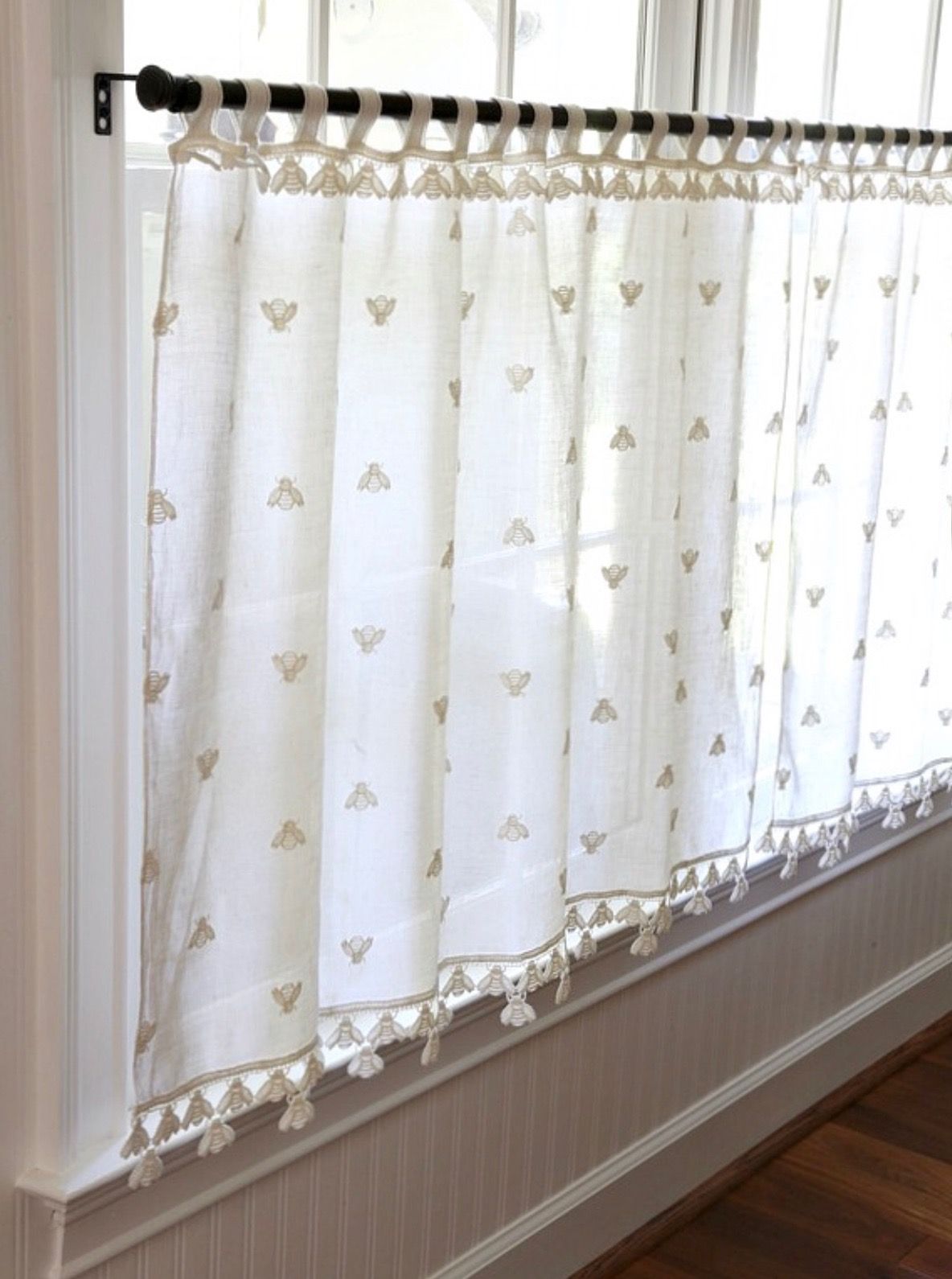 Curtain rod extender attached to a window curtain rod showing extended length