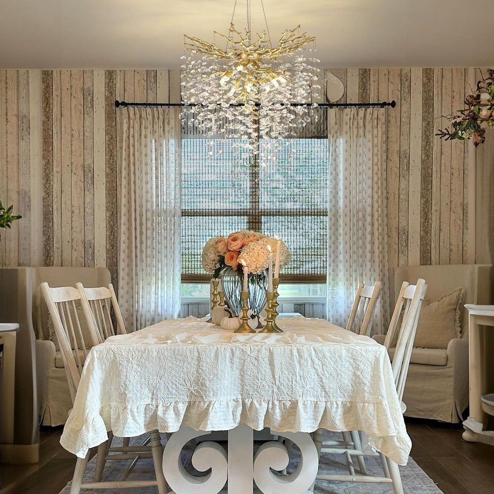 Stylish dining room with floor-length curtains framing a large window