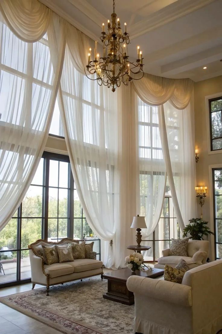 Elegant living room with floor-to-ceiling sheer curtain panels, chandelier, and classic furniture