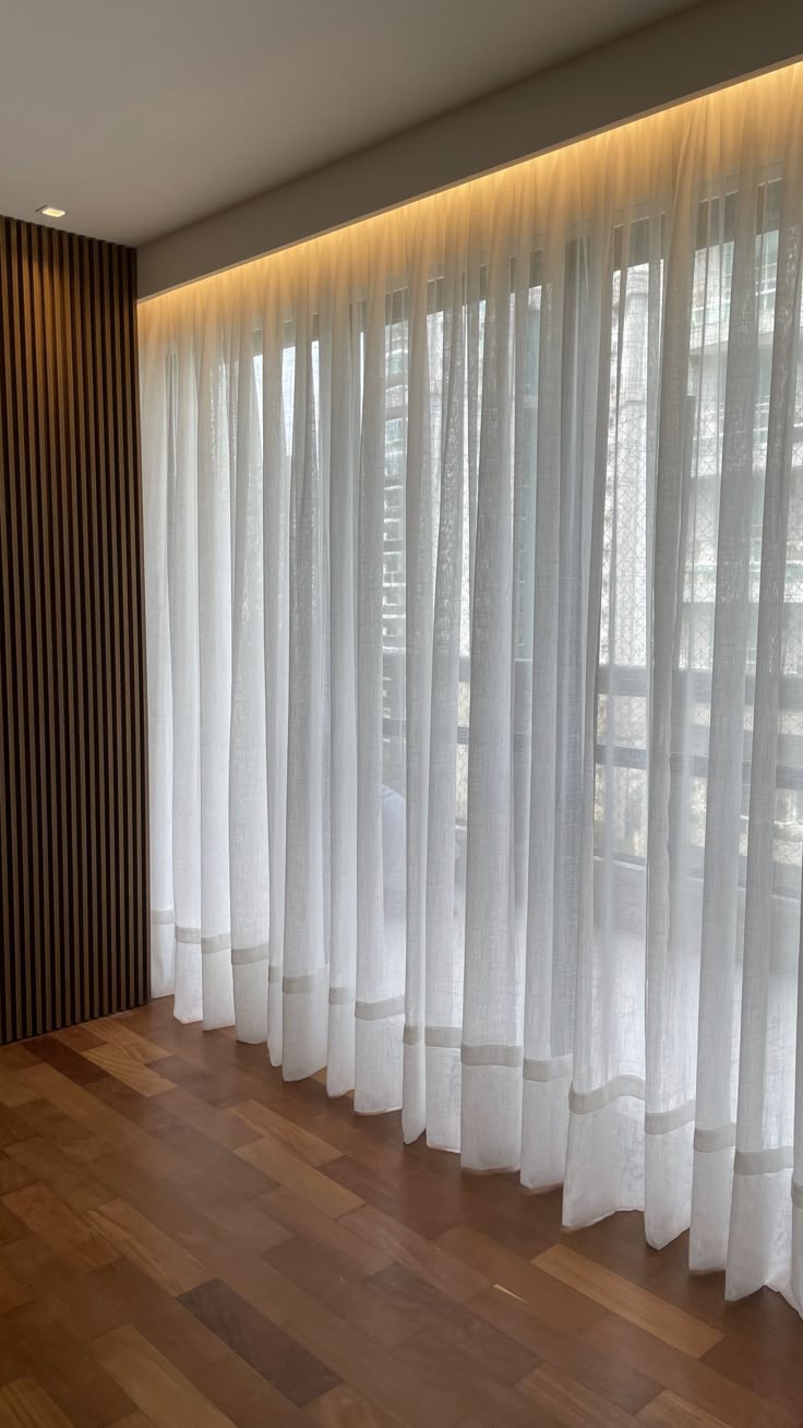 Ceiling-mounted curtain brackets holding elegant drapes in a modern living room