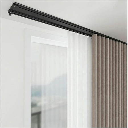 DIY ceiling mounted curtain track system with sheer and blackout curtains by a window