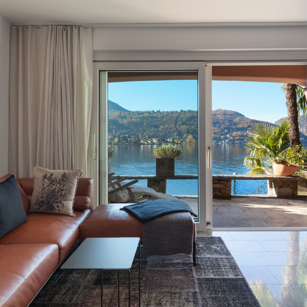  Modern living space featuring sleek ceiling-mounted curtain rail system with elegant drapes
