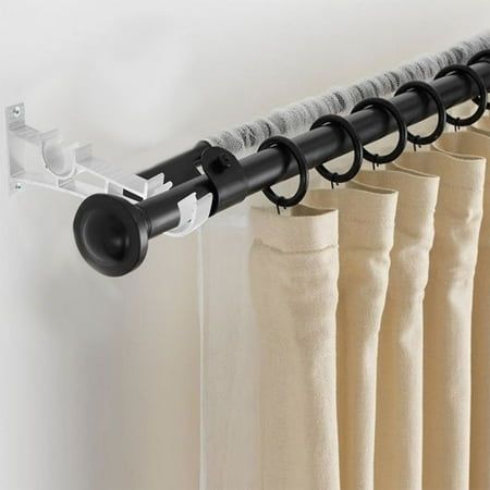 Beige blackout curtain hanging on black curtain rod with easy-install track system