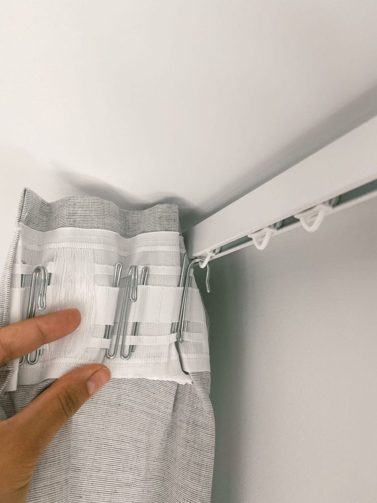 Stylish drapery rods for sliding doors mounted above elegant floor-length curtains