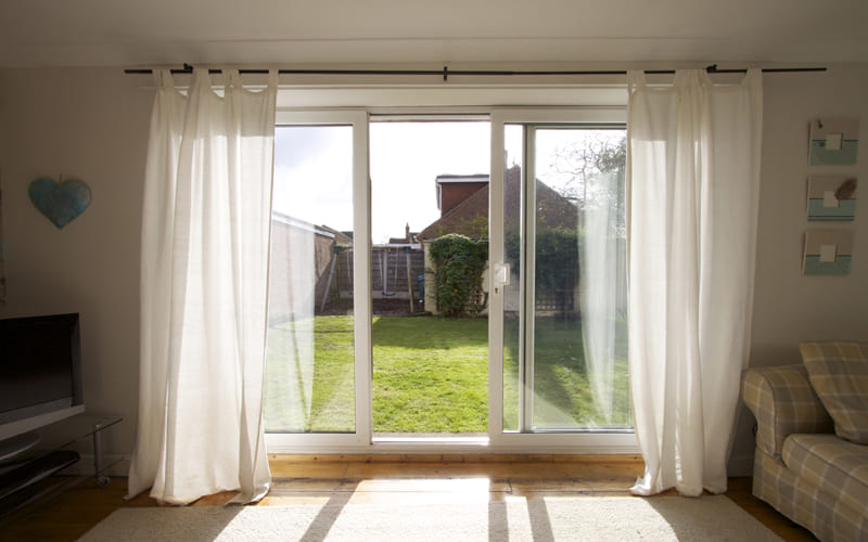 stylish curtains for sliding glass doors framing a bright and airy patio view