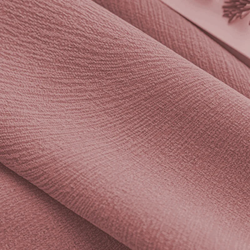 Close-up of pink textured blackout curtain fabric with soft folds