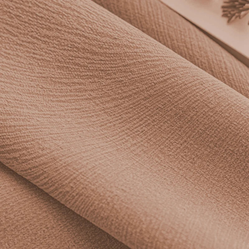 Close-up of textured, peach blackout curtain fabric with soft thermal weave
