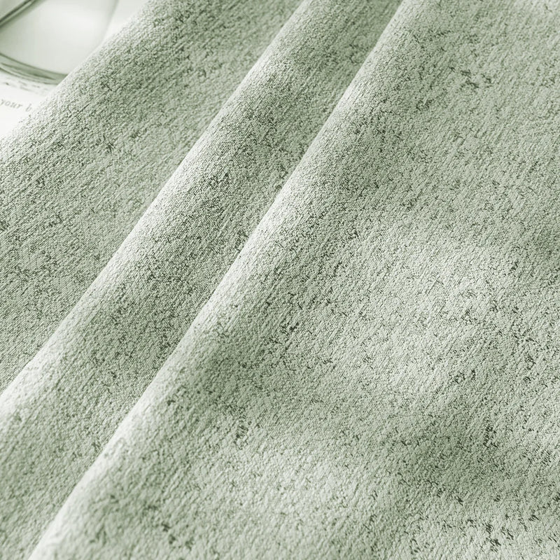 Light green textured blackout curtain fabric with soft pleats and modern pattern