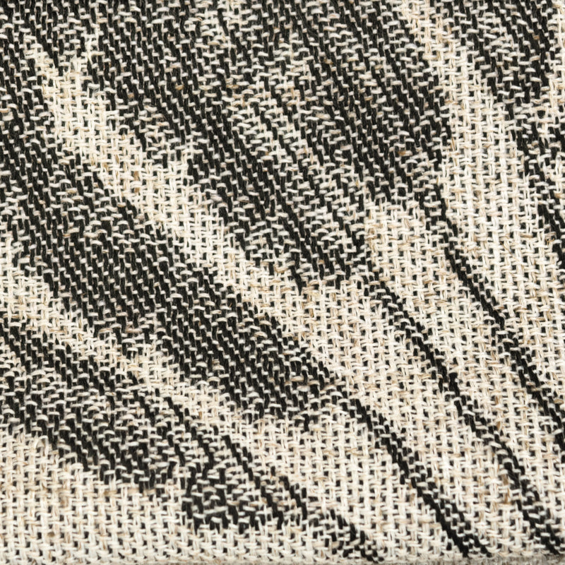 Close-up of black and white woven curtain fabric texture with abstract pattern