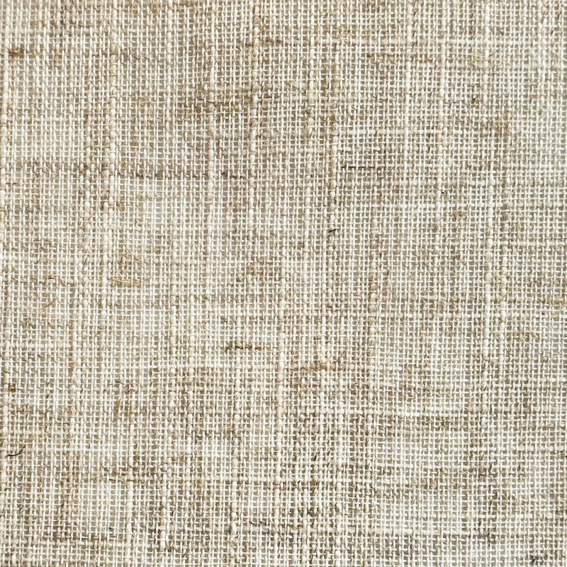 close-up of beige linen textured curtain fabric, natural woven pattern