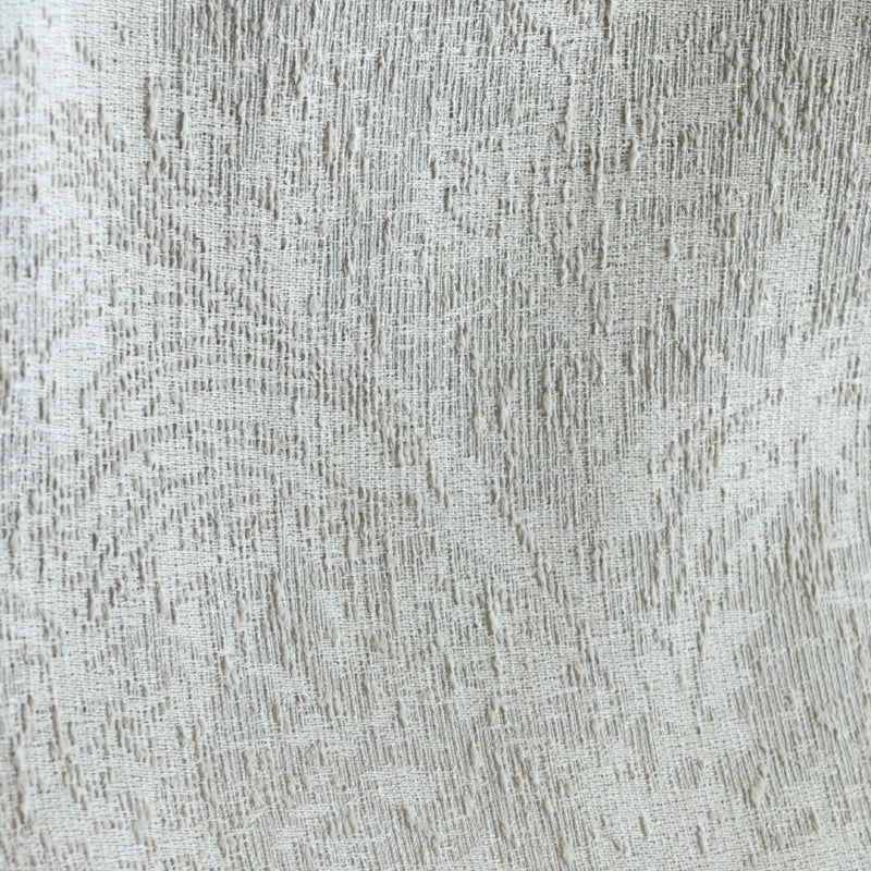 Textured beige curtain fabric with subtle woven pattern, ideal for blackout or thermal curtains