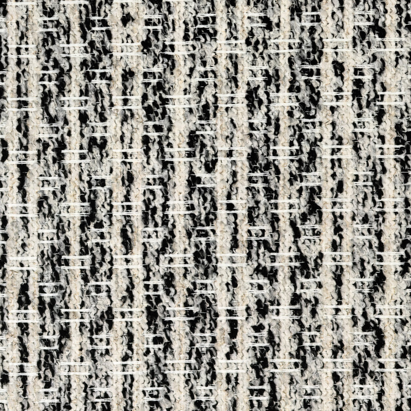 Close-up of textured blackout curtain fabric with black and cream woven pattern