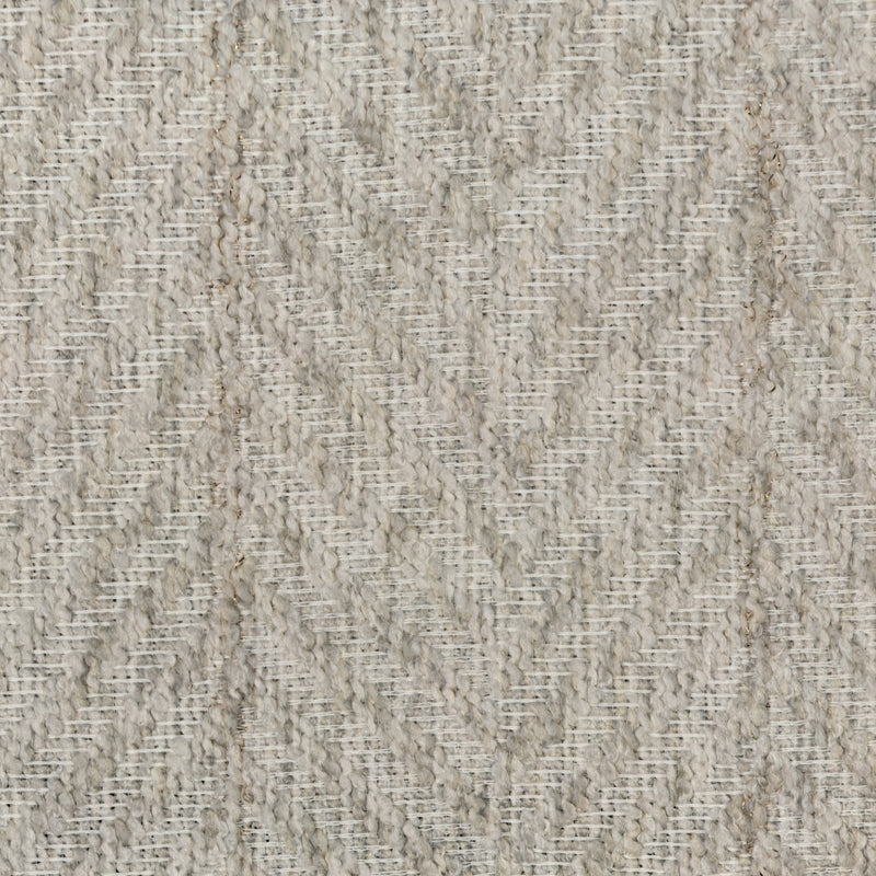 Close-up of textured beige curtain fabric with subtle chevron pattern, blackout material
