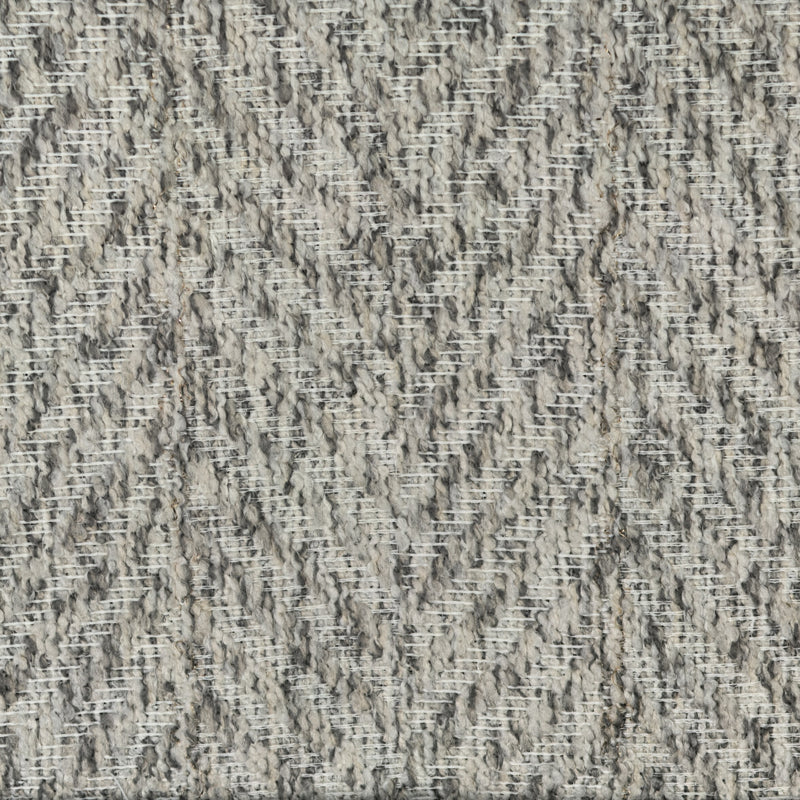 Close-up of textured grey curtain fabric with a chevron weave pattern