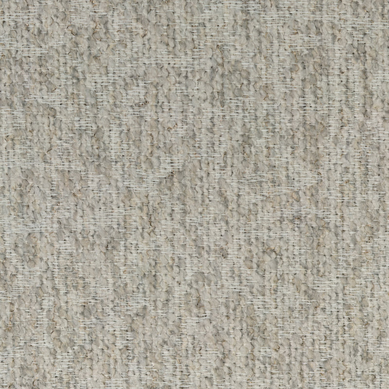 Closeup of textured beige blackout curtain fabric with woven boucle pattern