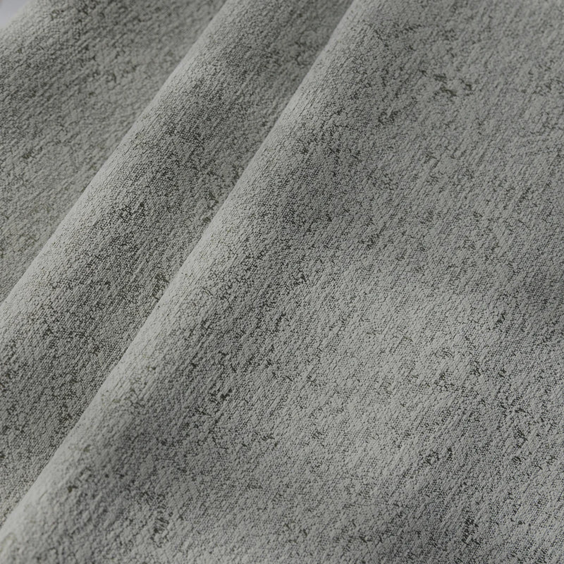 Close-up of textured grey blackout curtain fabric with soft folds