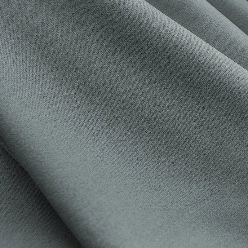 Close-up of grey blackout thermal curtain fabric with soft texture and gentle folds
