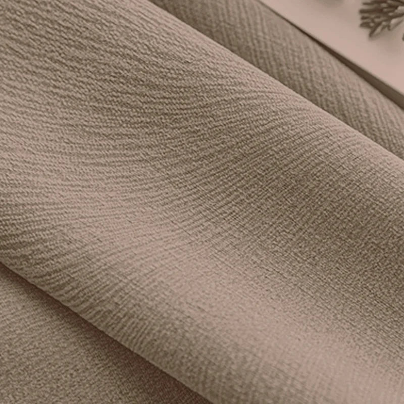 Close-up of textured beige blackout curtain fabric for window treatments