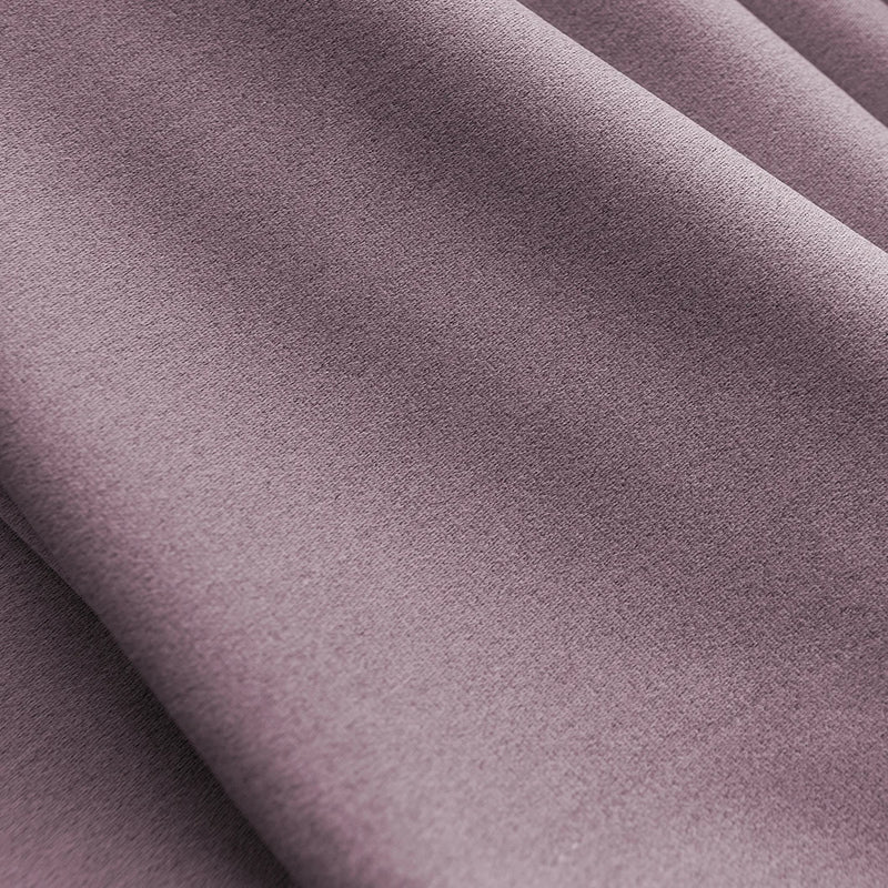 Close-up of soft mauve blackout curtain fabric with gentle folds and smooth texture