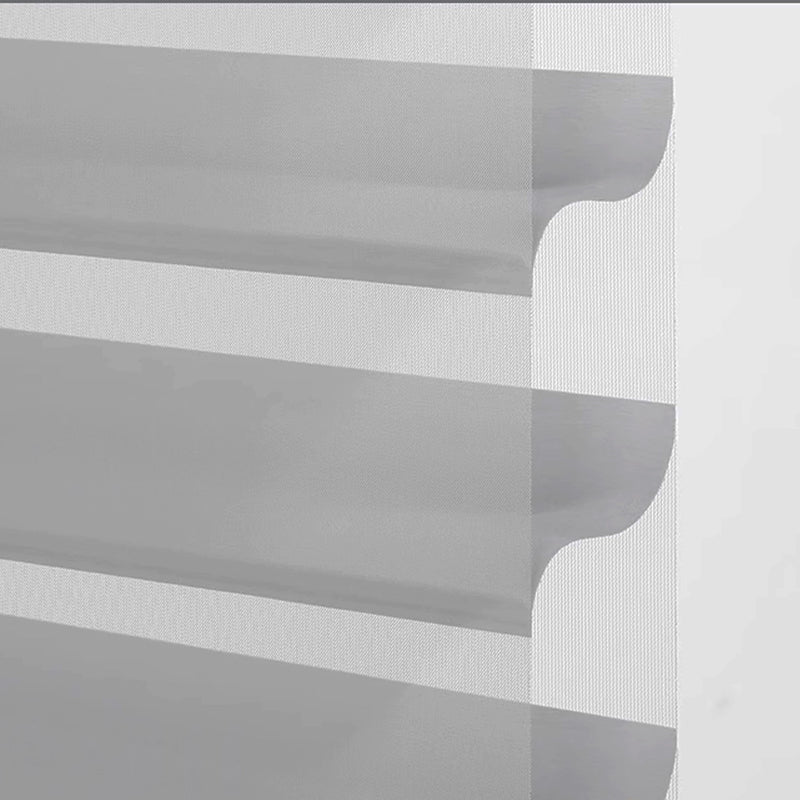 Close-up of modern sheer layered curtain panel with wave-shaped cutout design