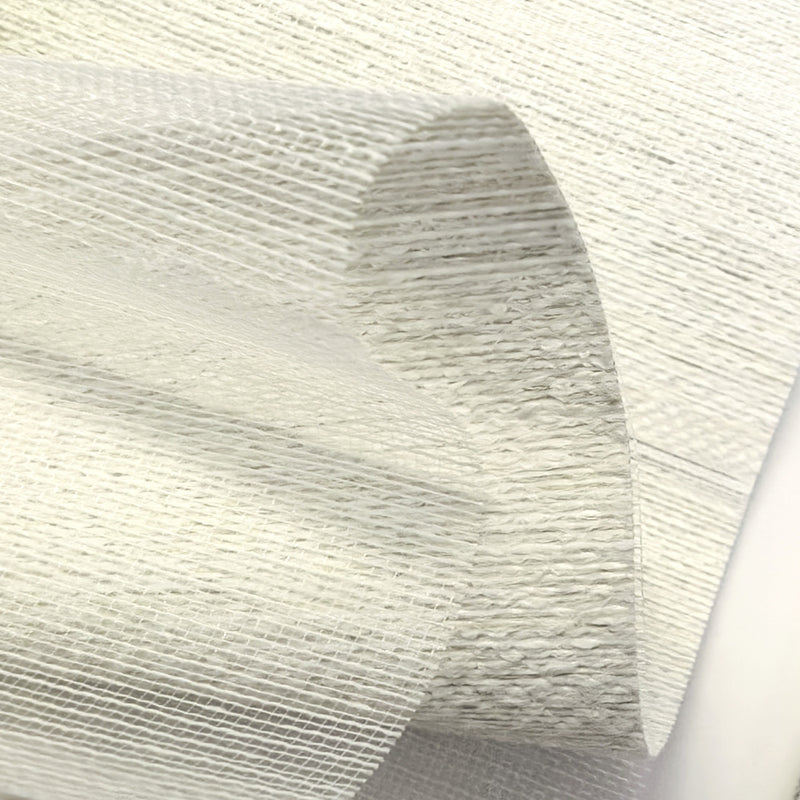 Close-up of textured white blackout curtain fabric with subtle grid pattern