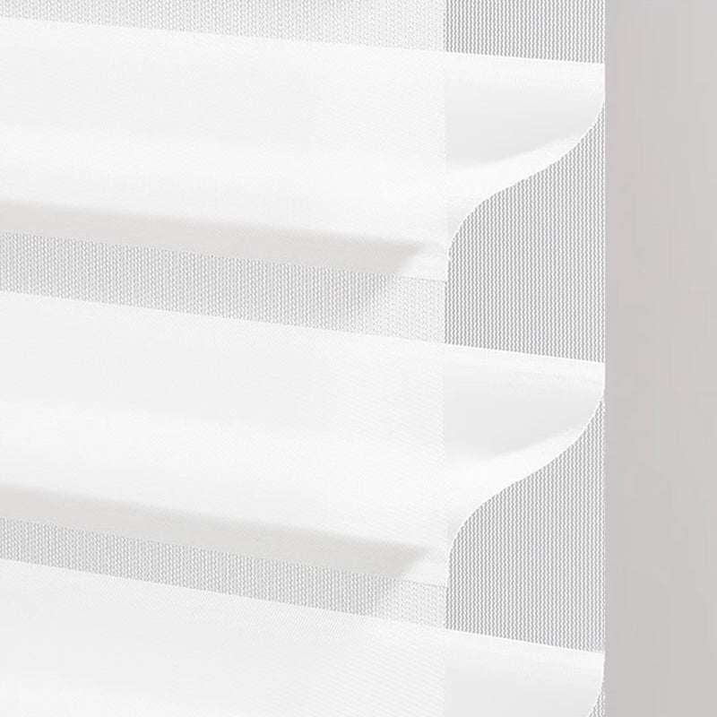 Close-up of white layered sheer curtain with textured fabric on a window