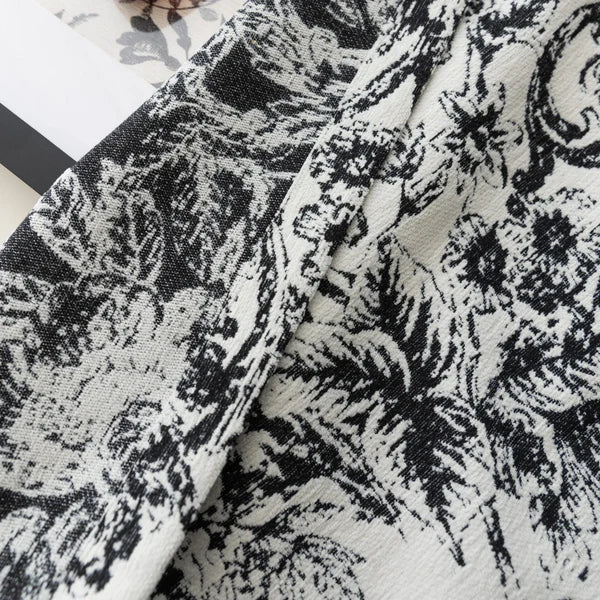 Black and white floral patterned curtain fabric with textured thermal weave