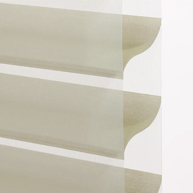 Close-up of beige layered sheer window blinds with alternating fabric and mesh panels