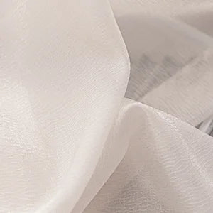 Close-up of sheer white curtain fabric with soft, lightweight texture suitable for windows.